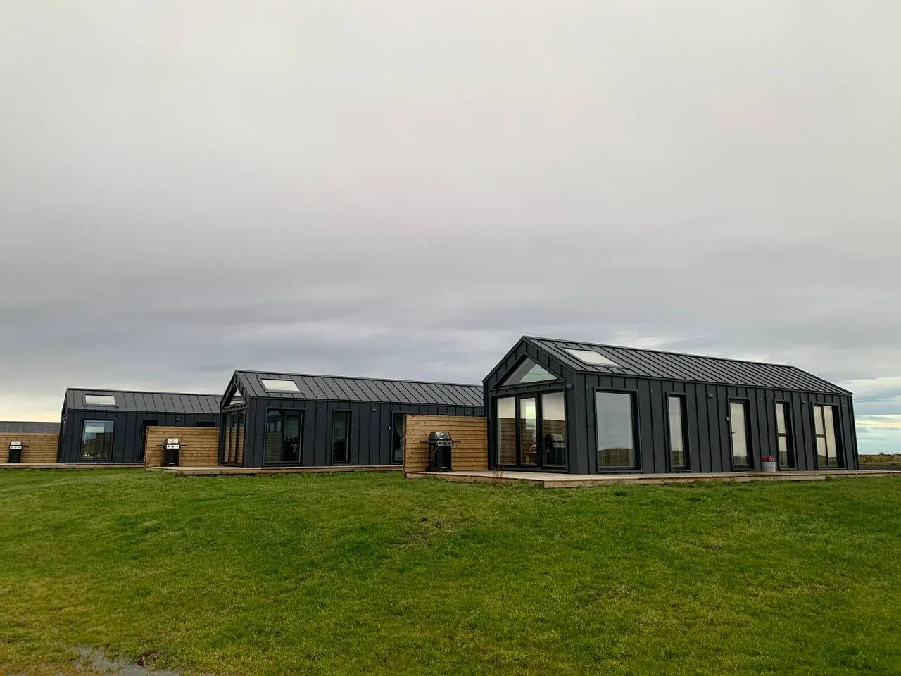Three built Bouw Art houses in a green meadow